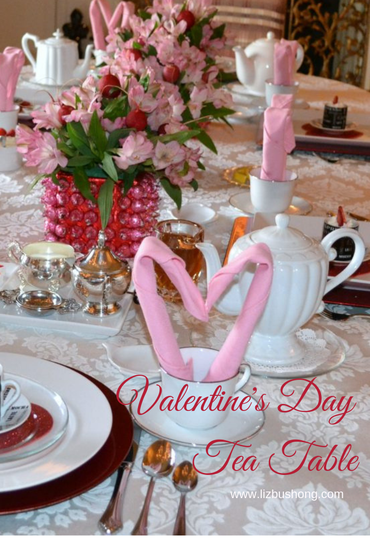 lizbushong.com Valentine Tea Table Scape, Simple, easy table setting featuring heart shaped napkin fold, pink kissed centerpiece, tea and pots de creme for dessert. Get Recipe and how to fold instructions here.