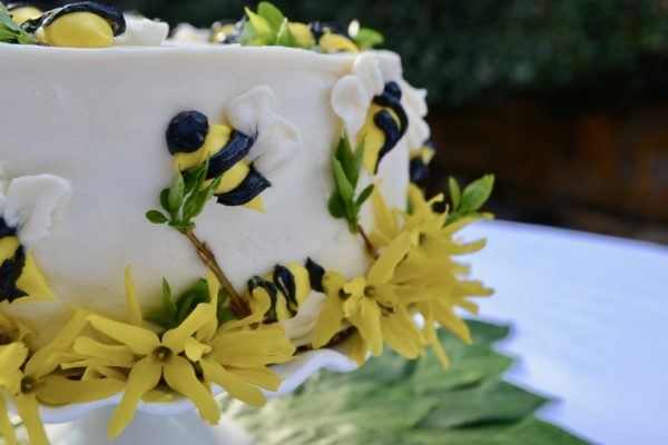 Honey cakes decorated with marzipan bees and flowers