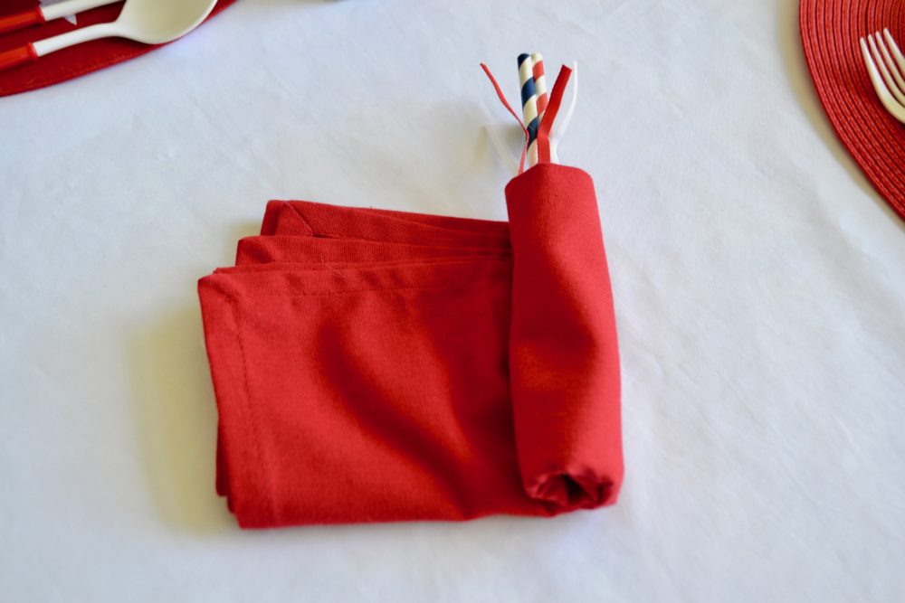 DIY Firecracker napkin fold for 4th of July table.
