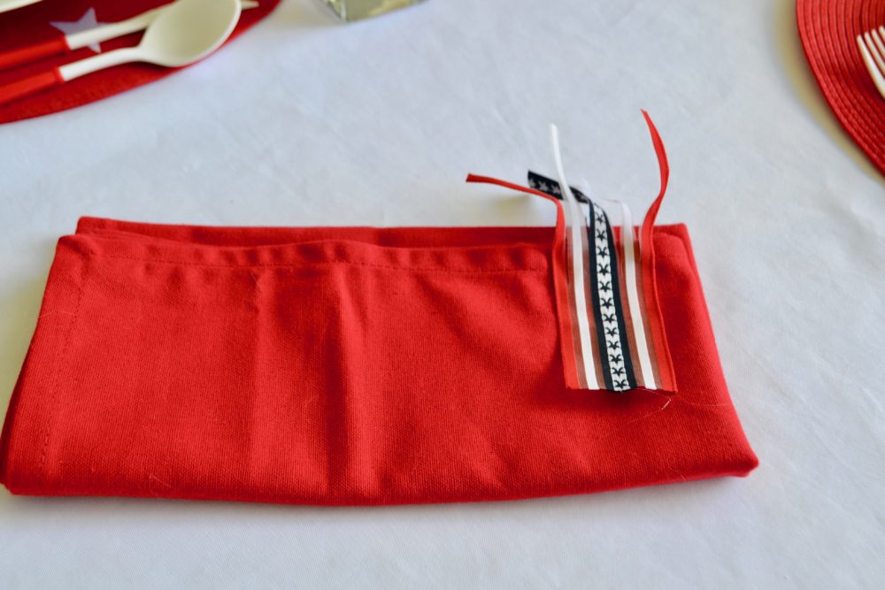 DIY Firecracker napkin fold for 4th of July table.