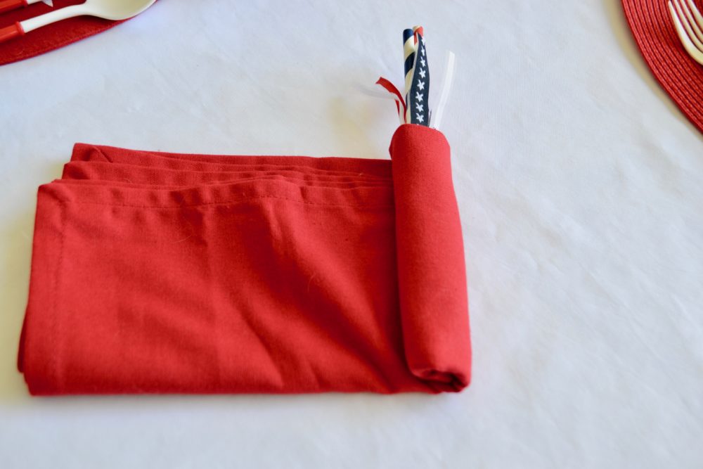 DIY Firecracker napkin fold for 4th of July table.